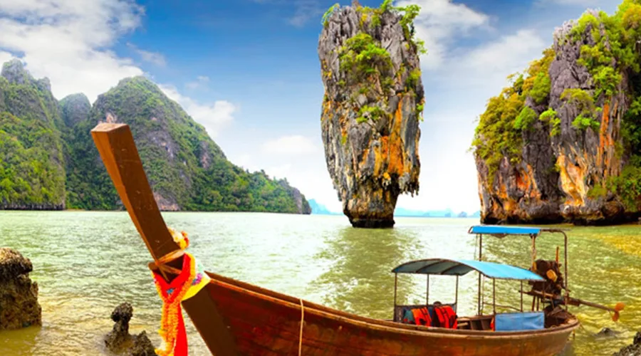 A longtail boat facing James Bond Island