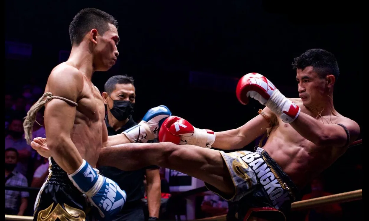Two fighters in a kick exchange
