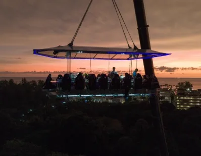 The Dinner in the Sky table suspended above Phuket at dusk