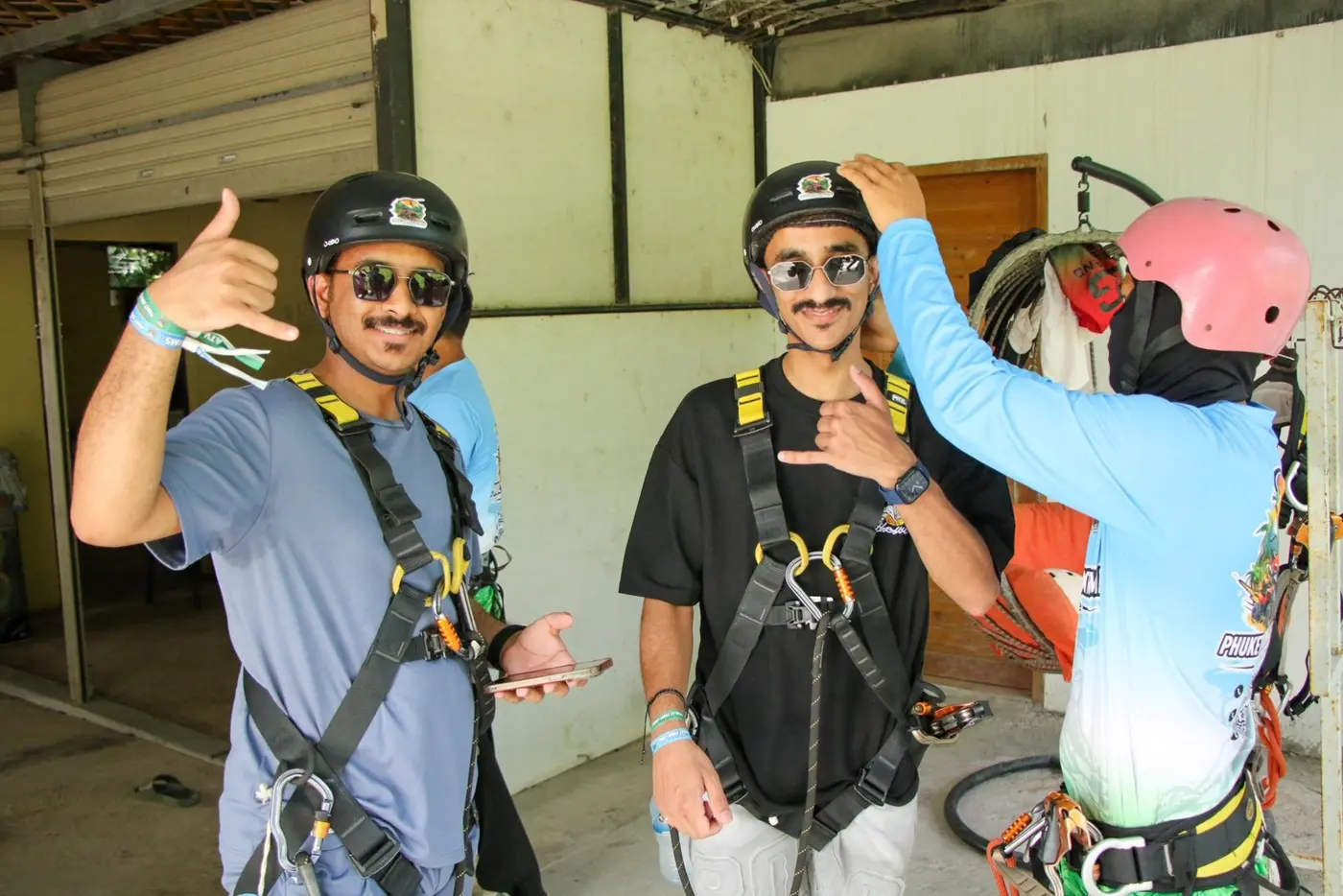 Two travelers in harnesses in the gear room before departure