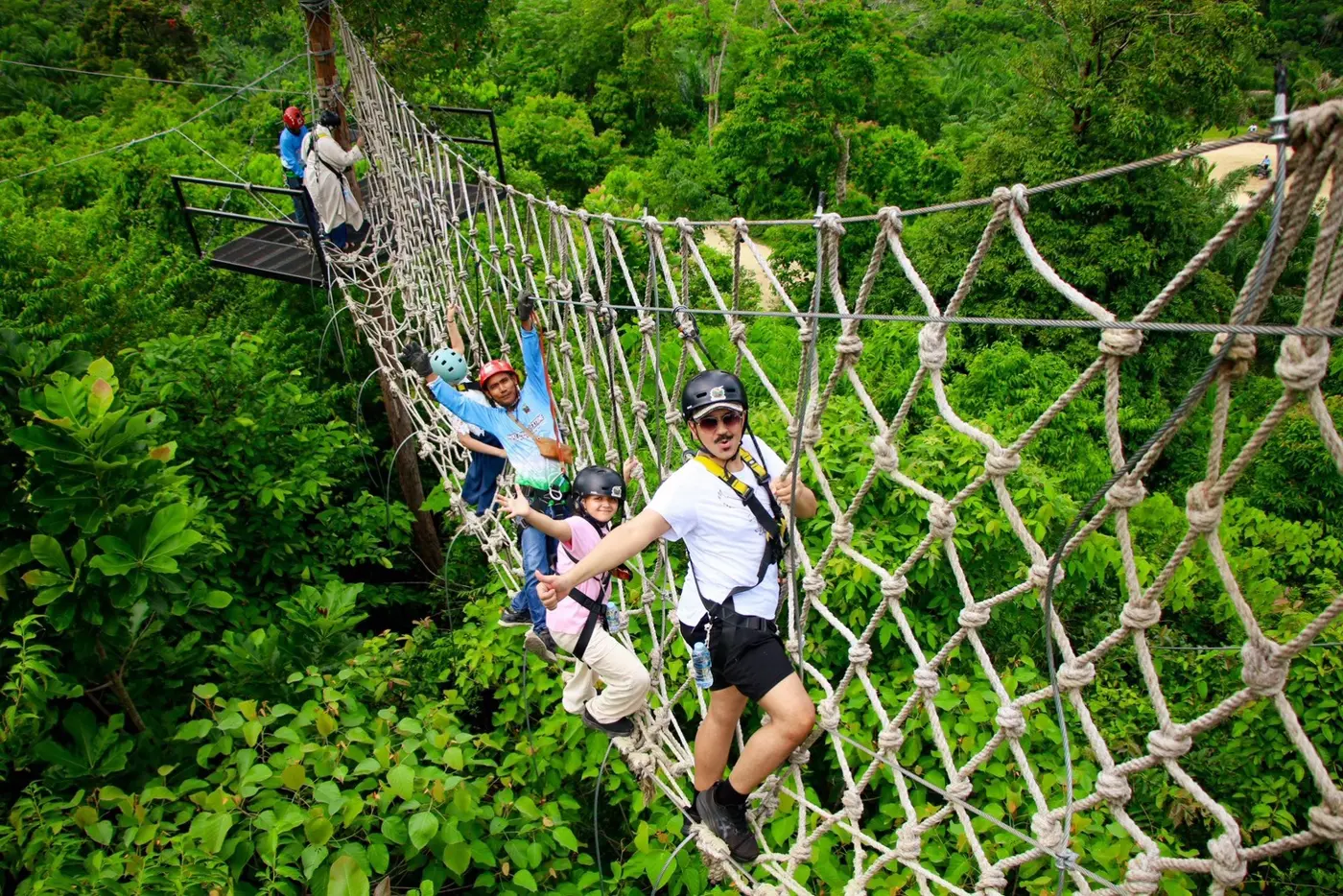 A traveler on a long rope-net bridge