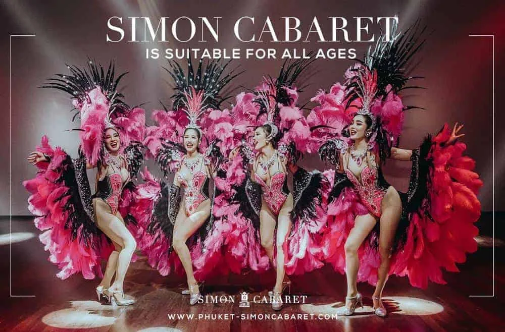 Four performers in pink and red feather costumes with fans
